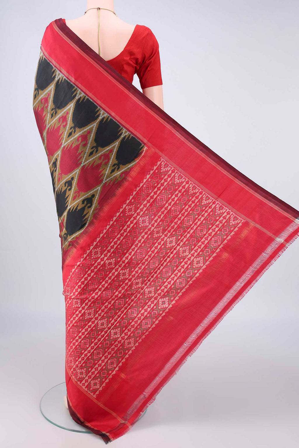 Flat view of Pure Silk Black Pochampally Saree with Pure Ikat on the body and Zari Border. 
