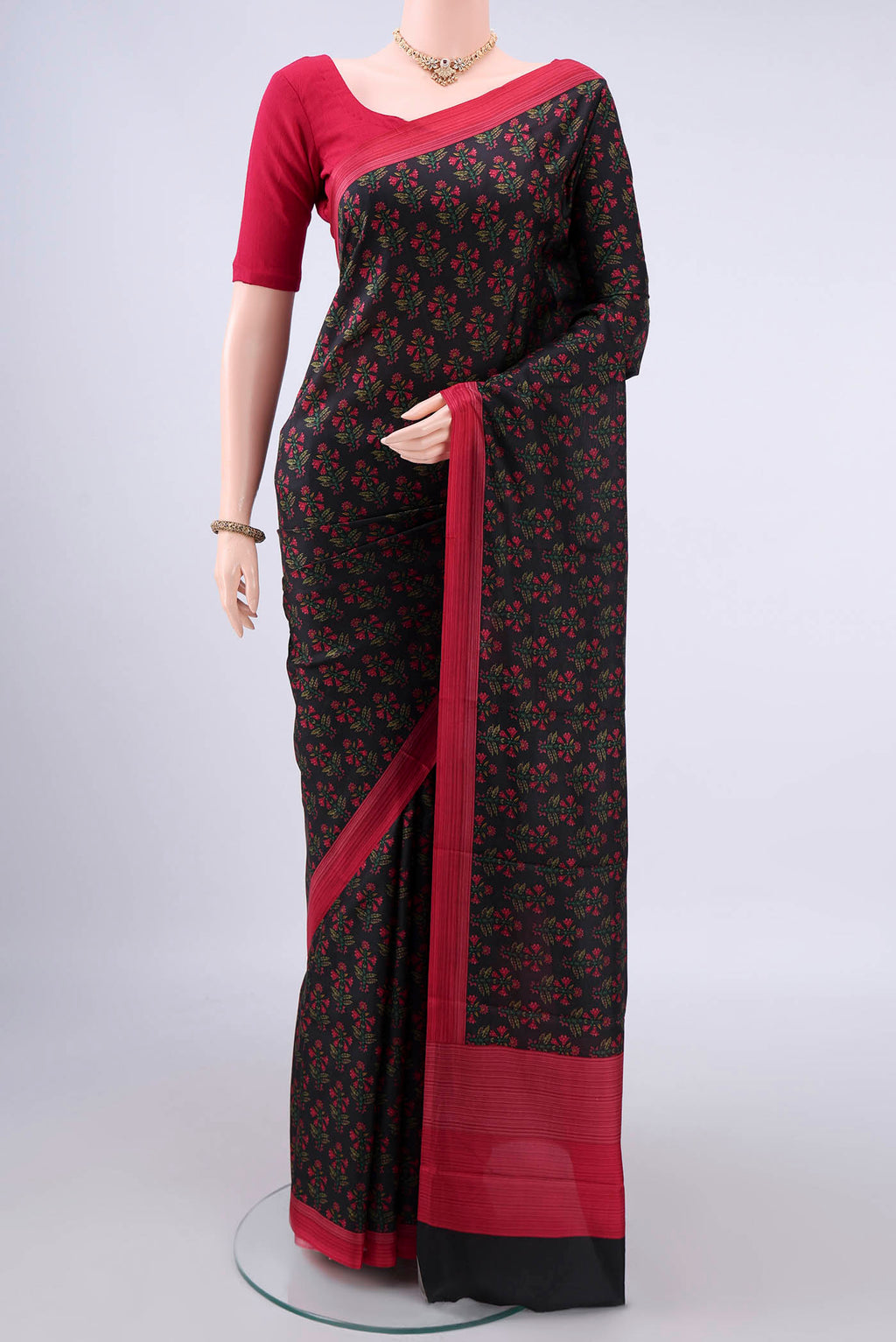 Pure Silk Black Printed Saree with Printed design on the body and Printed Border.  displayed on a mannequin