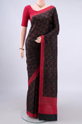 Pure Silk Black Printed Saree with Printed design on the body and Printed Border.  displayed on a mannequin