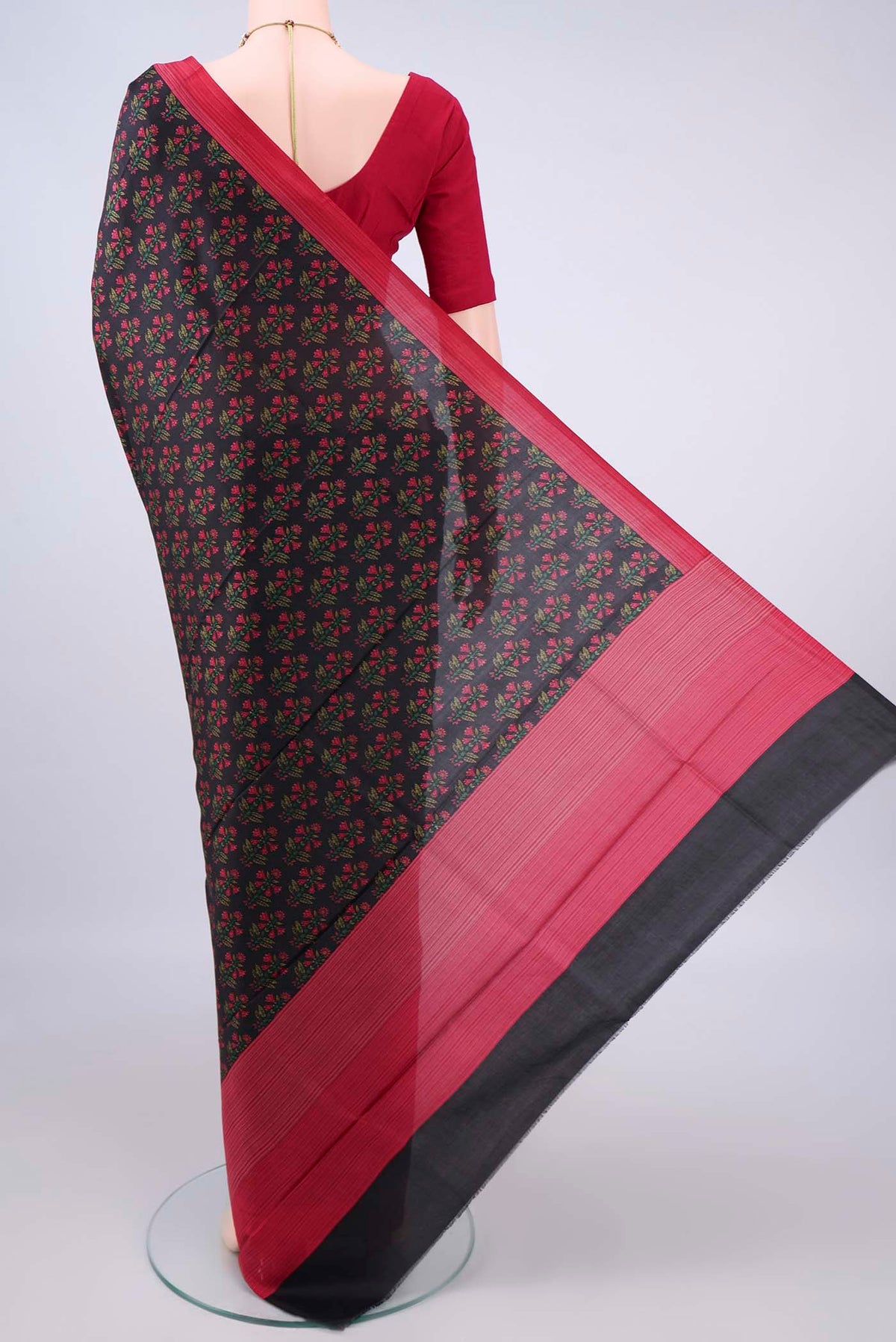 Flat view of Pure Silk Black Printed Saree with Printed design on the body and Printed Border. 