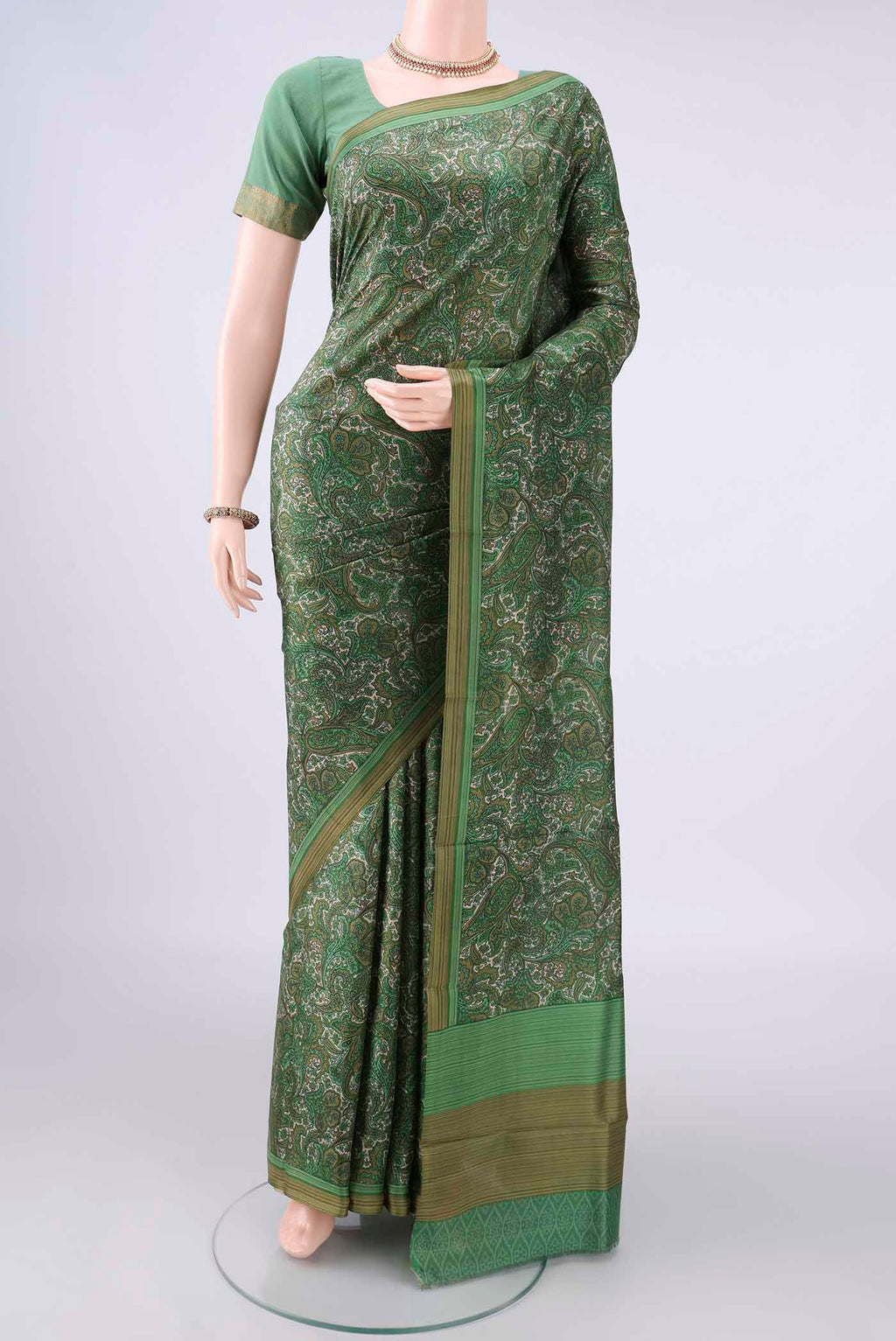 Pure Silk Green Printed Saree with Printed design on the body and Plain Border.  displayed on a mannequin