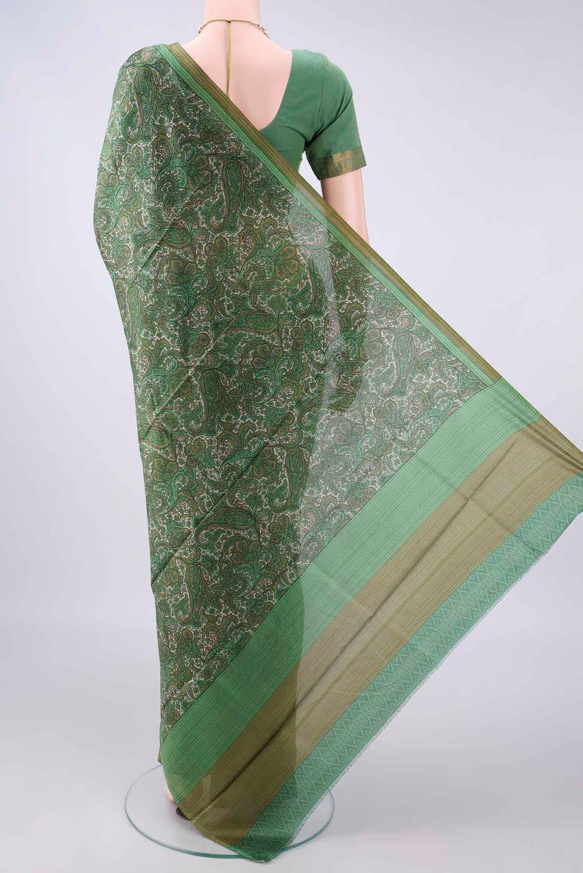 Flat view of Pure Silk Green Printed Saree with Printed design on the body and Plain Border. 