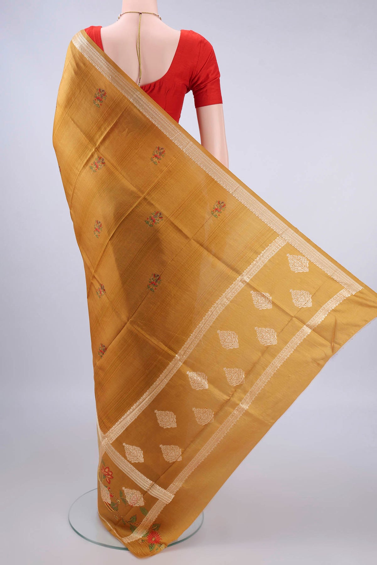 Flat view of Pure Silk Mustard Printed Saree with Printed design on the body and Thread Border. 