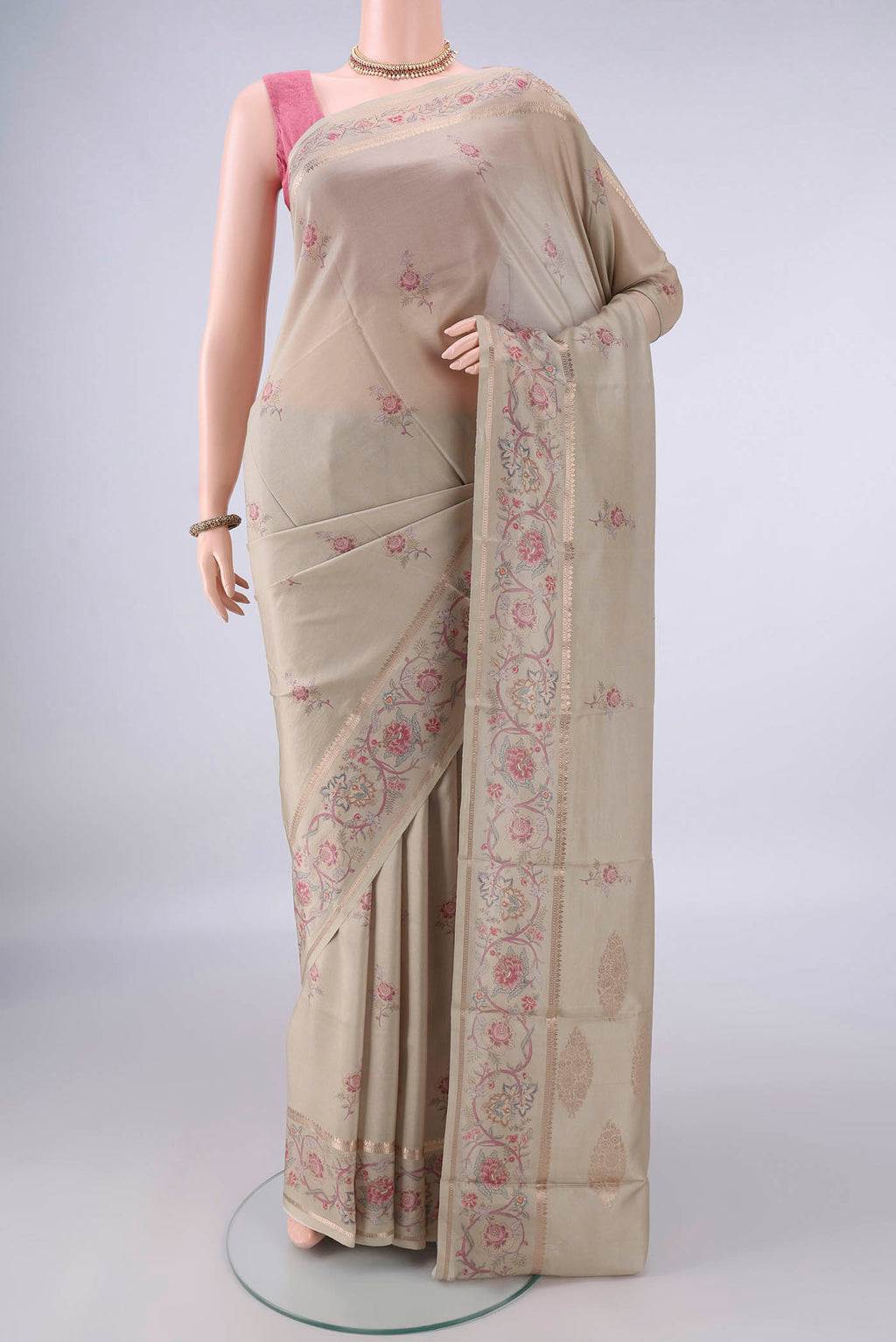 Pure Silk Beige Printed Saree with Printed design on the body and Zari Border.  displayed on a mannequin
