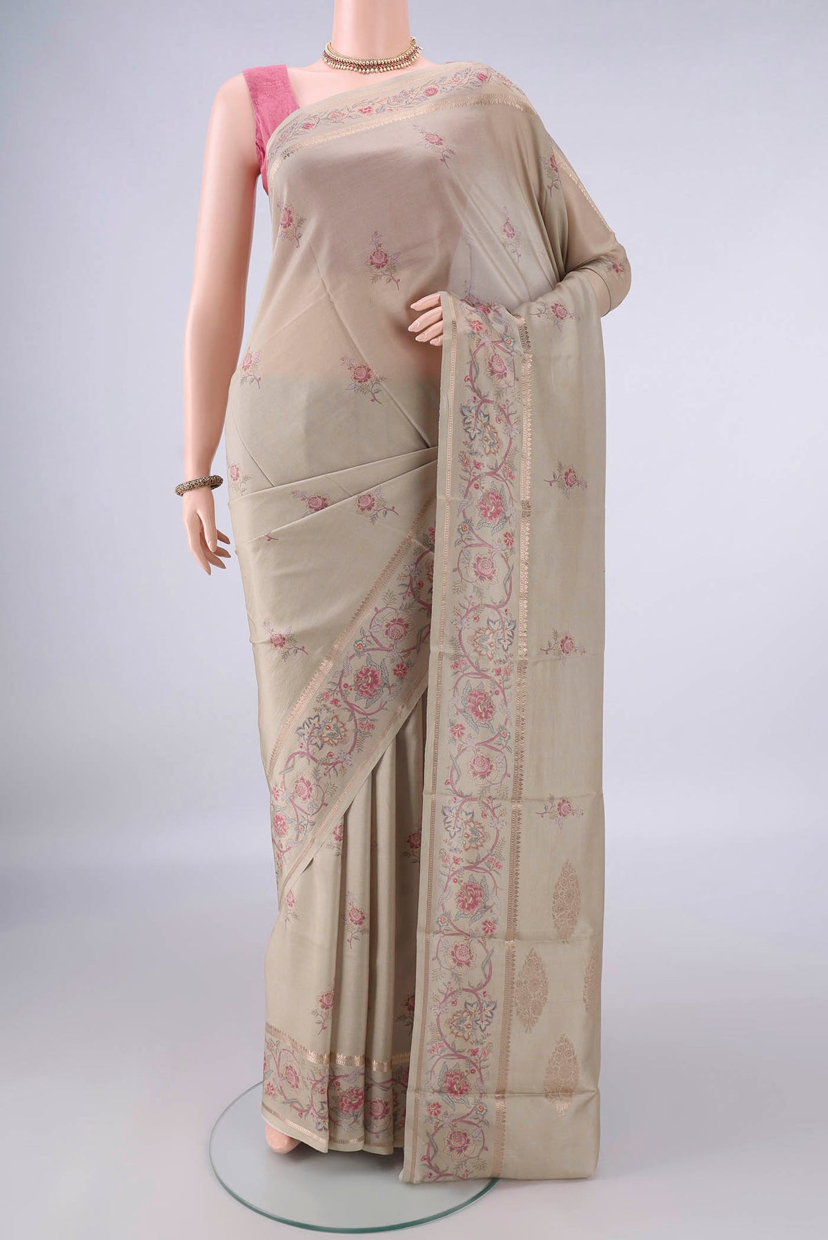 Pure Silk Beige Printed Saree with Printed design on the body and Zari Border.  displayed on a mannequin