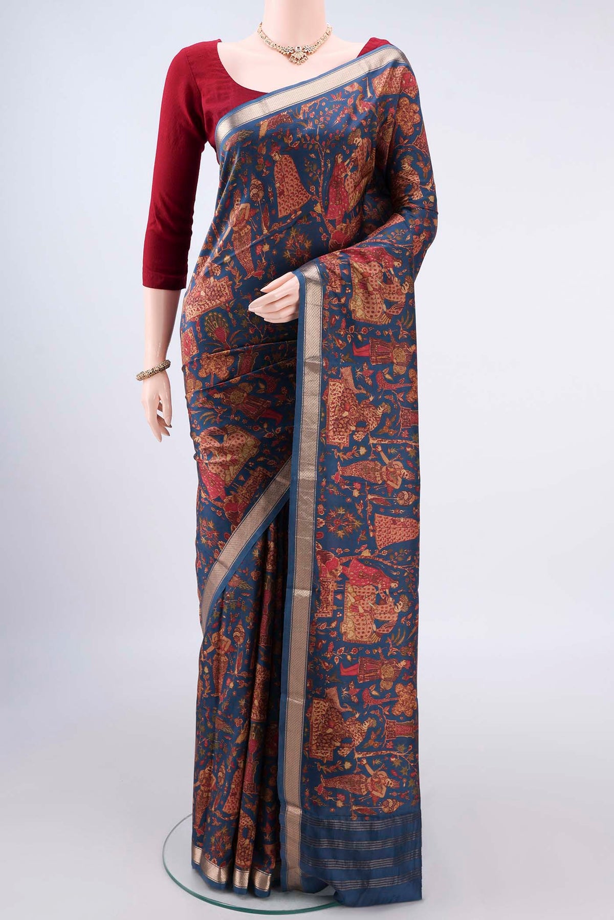 Pure Silk Peacock Blue Printed Saree with Printed design on the body and Zari Border.  displayed on a mannequin