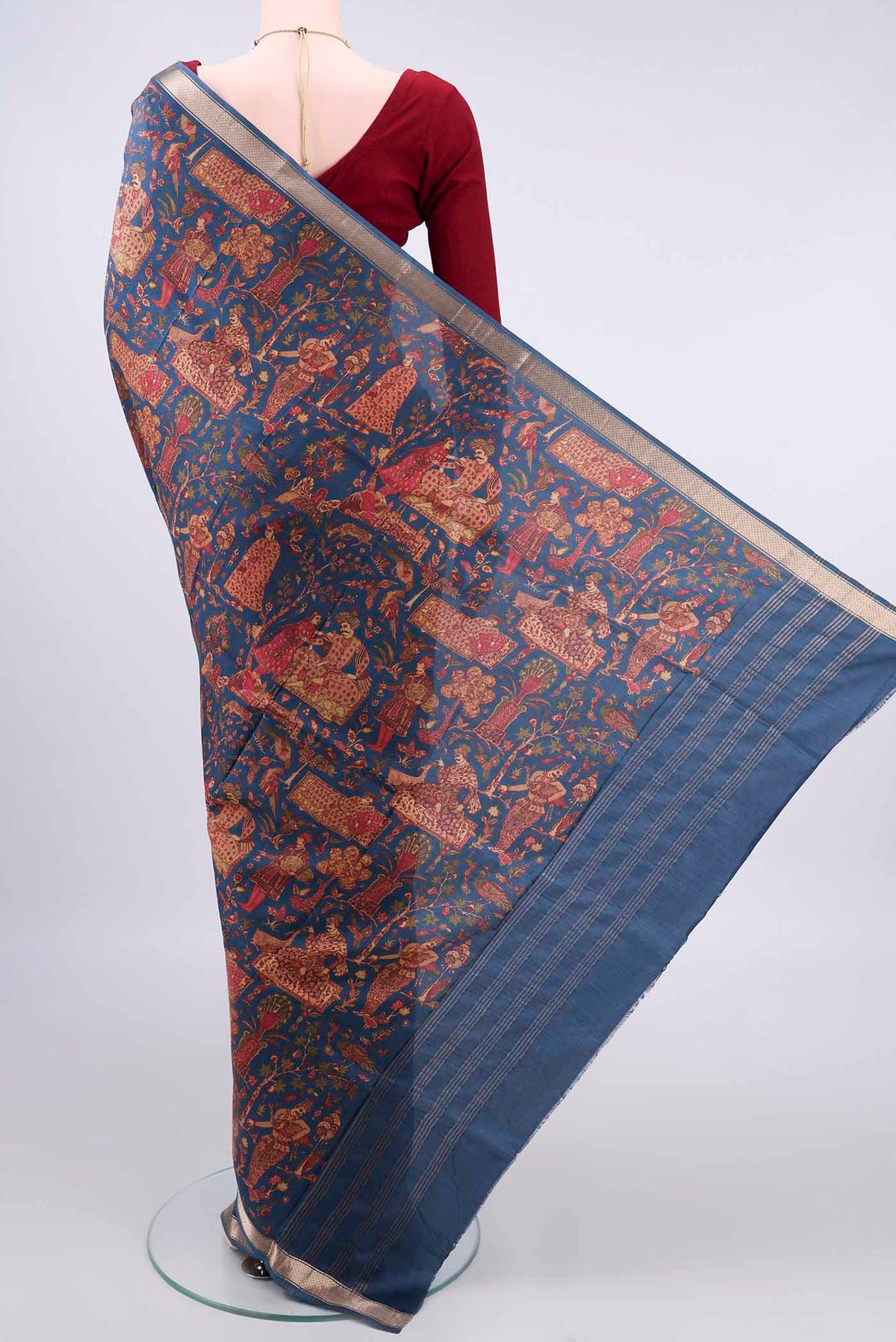 Flat view of Pure Silk Peacock Blue Printed Saree with Printed design on the body and Zari Border. 