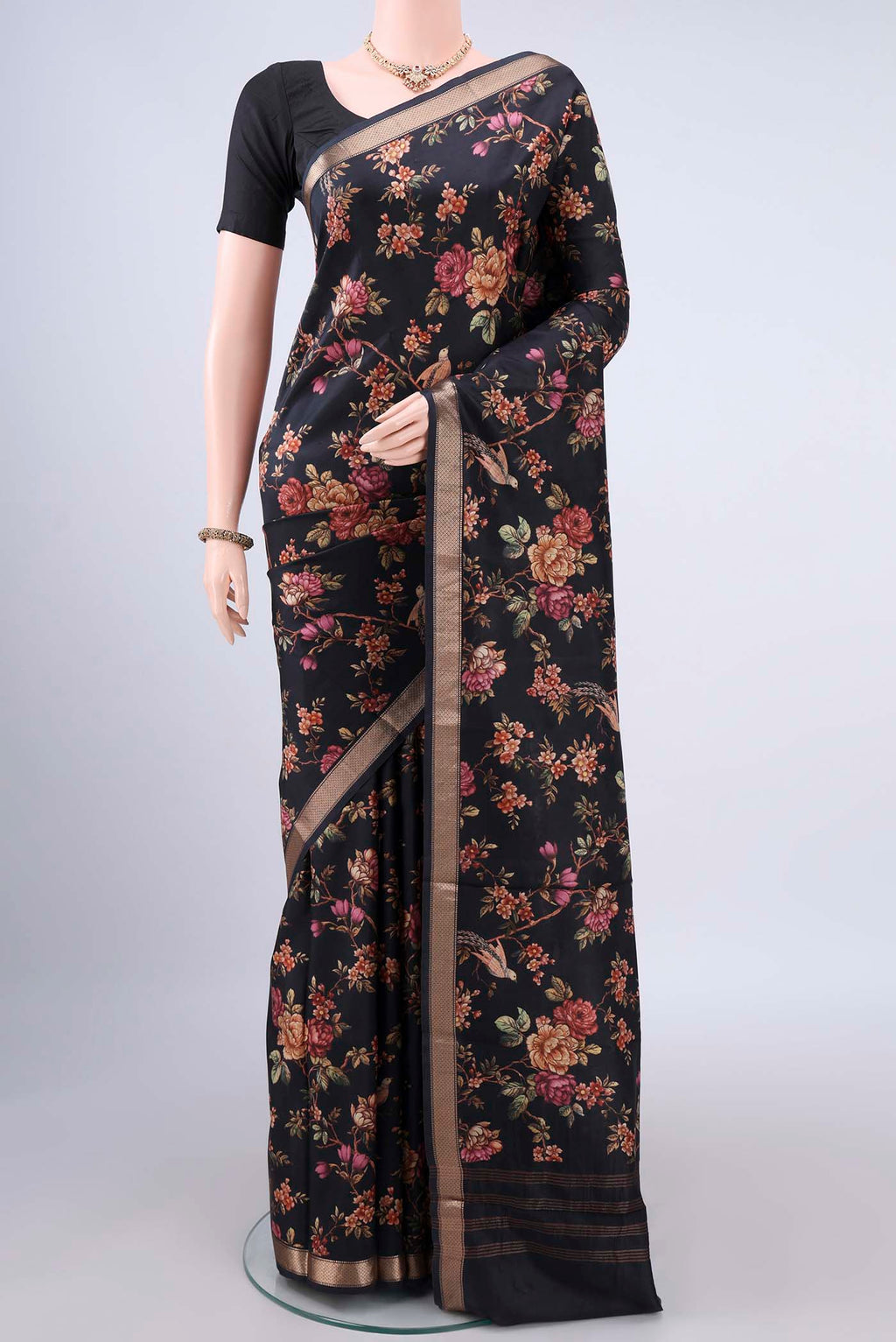 Pure Silk Black Printed Saree with Printed design on the body and Zari Border.  displayed on a mannequin