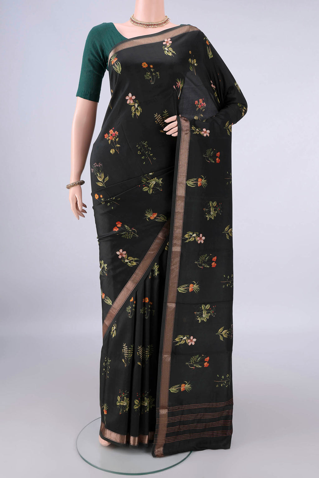 Pure Silk Bottle Green Printed Saree with Printed design on the body and Zari Border.  displayed on a mannequin