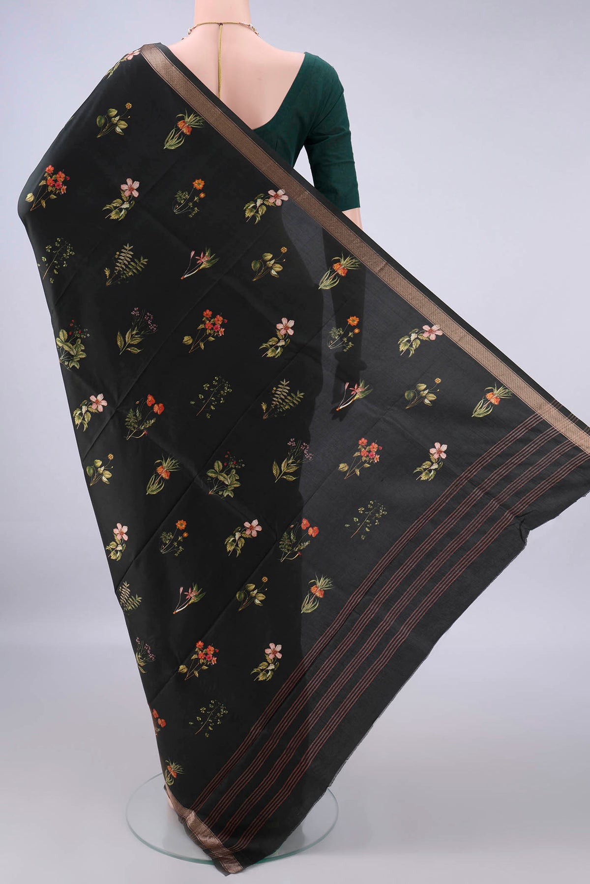 Flat view of Pure Silk Bottle Green Printed Saree with Printed design on the body and Zari Border. 