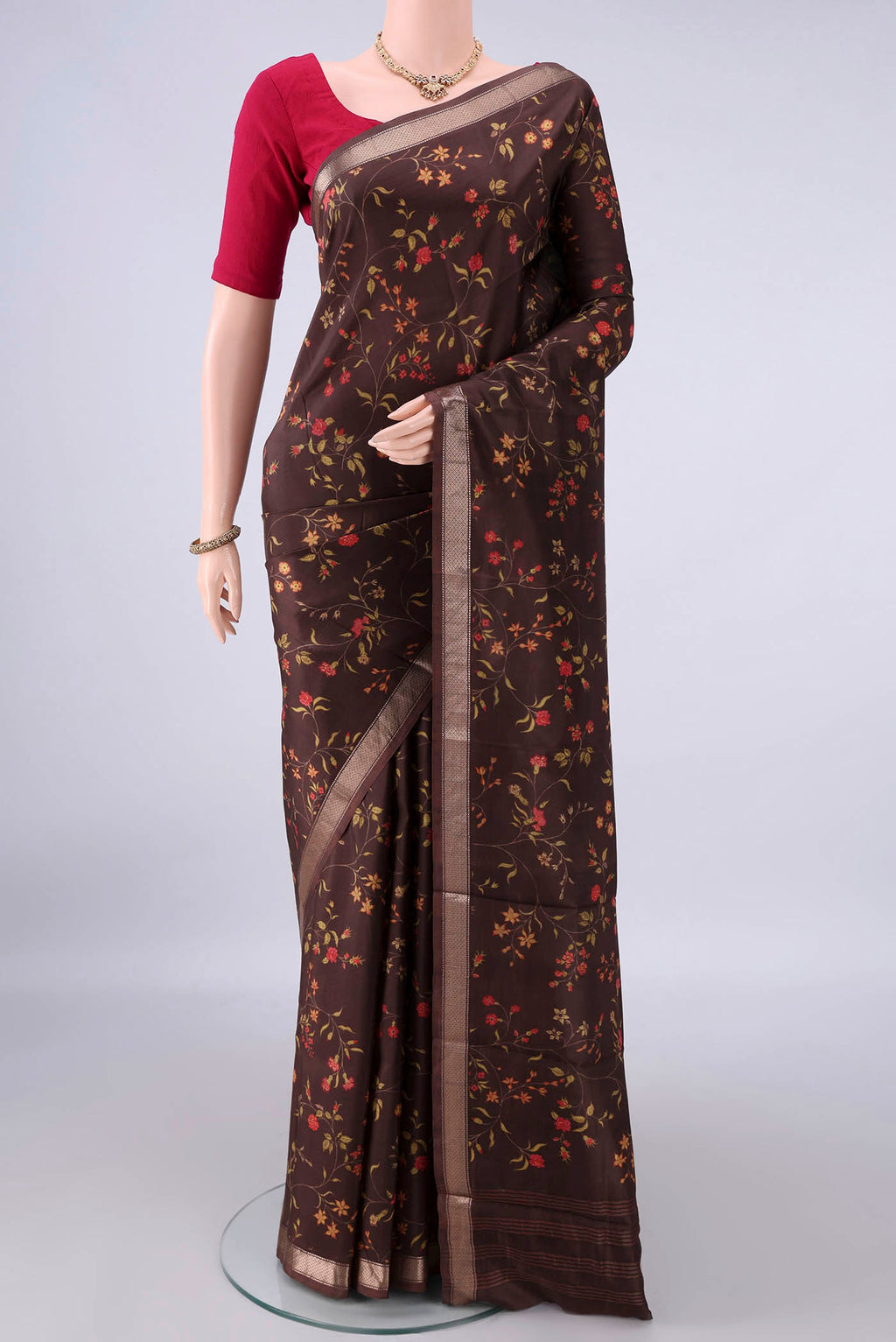 Pure Silk Brown Printed Saree with Printed design on the body and Zari Border.  displayed on a mannequin