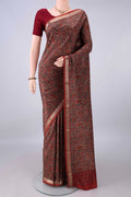 Pure Silk Rust Printed Saree with Printed design on the body and Zari Border.  displayed on a mannequin