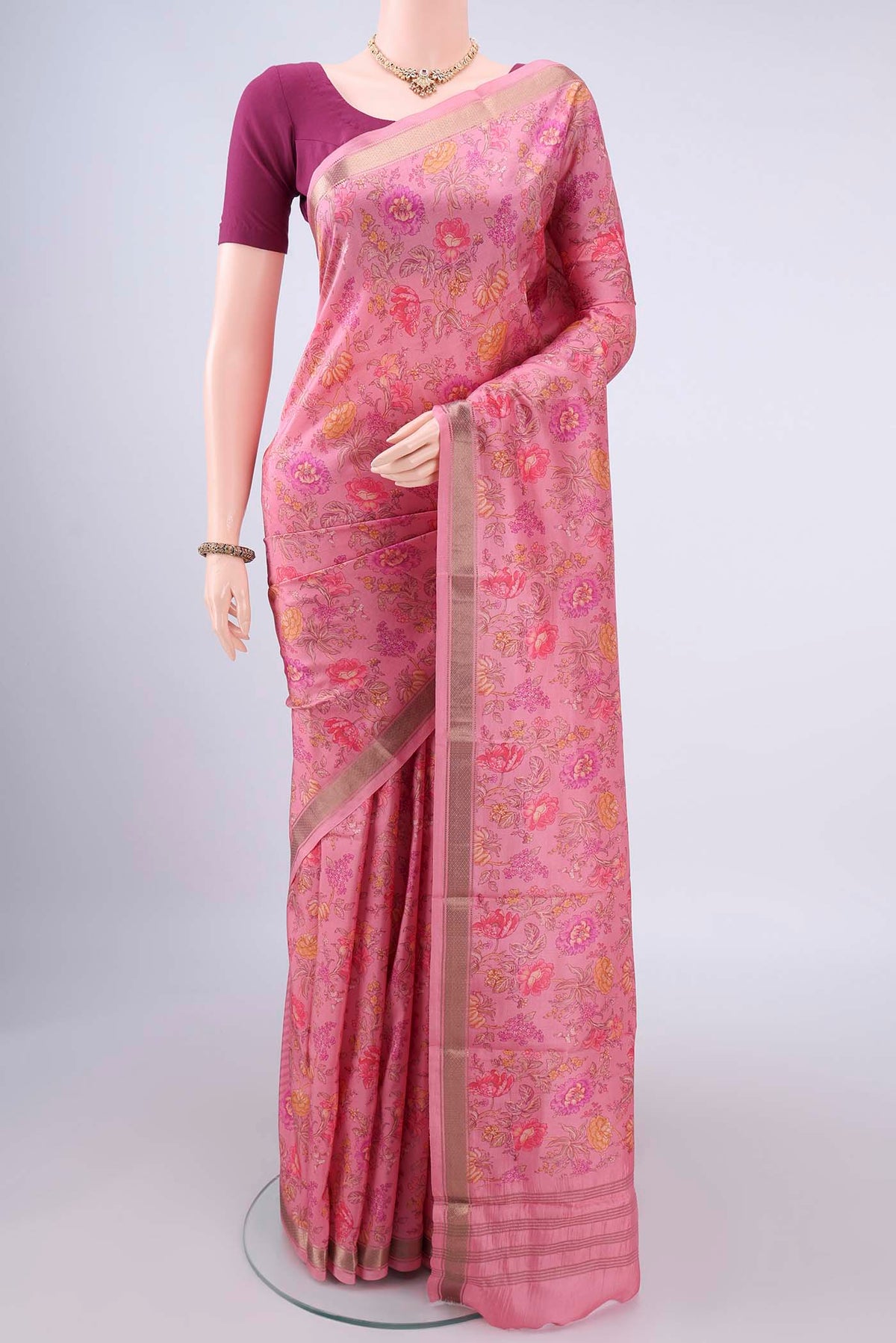Pure Silk Rose pink Printed Saree with Printed design on the body and Zari Border.  displayed on a mannequin