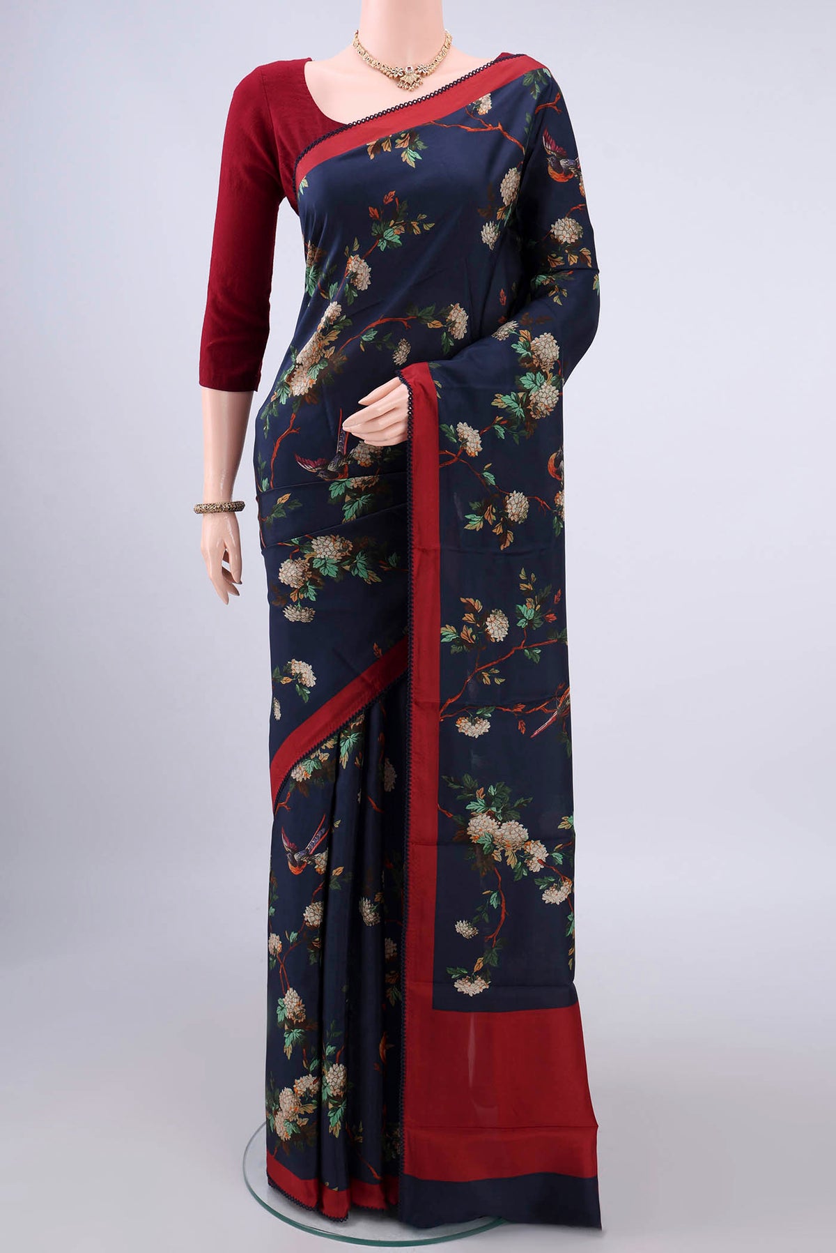 Pure Silk Navy Blue Printed Saree with Printed design on the body and Thread Border.  displayed on a mannequin