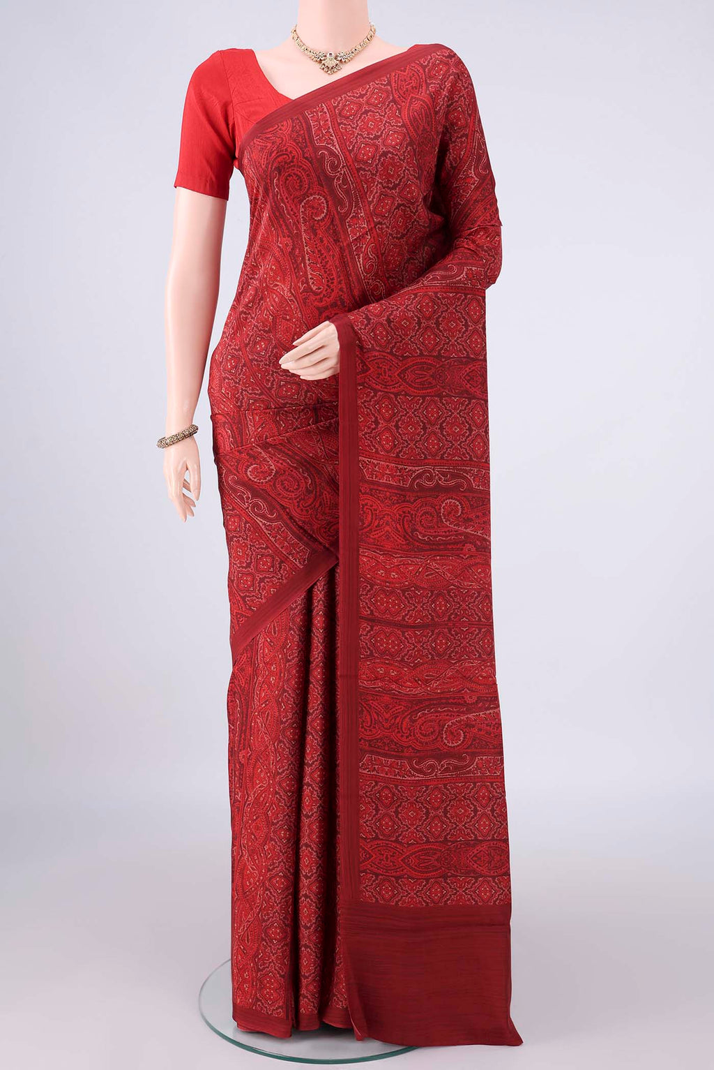 Pure Silk Red Printed Saree with Printed design on the body and Plain Border.  displayed on a mannequin