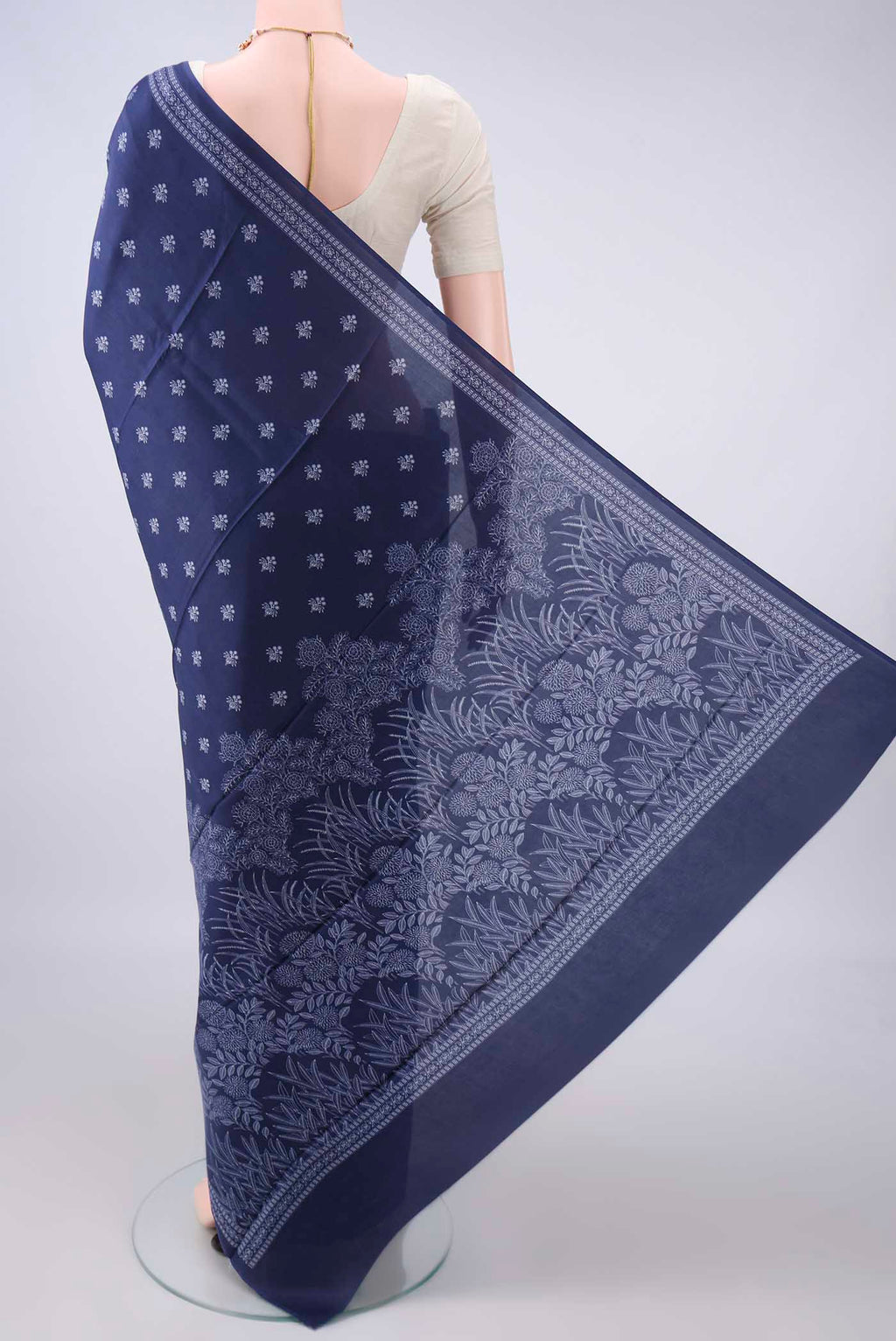 Flat view of Pure Silk Navy Blue Printed Saree with Printed design on the body and Plain Border. 