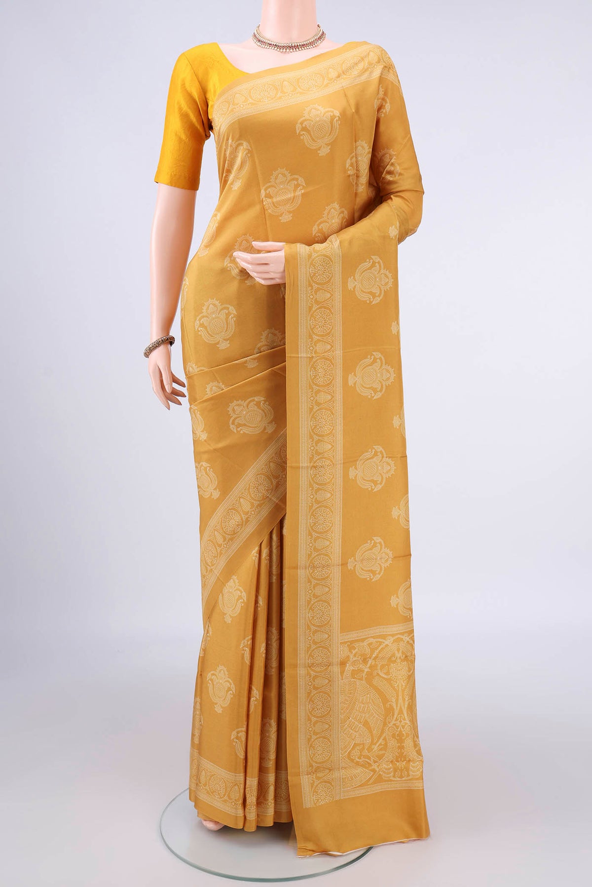 Pure Silk Mustard Printed Saree with Printed design on the body and Printed Border.  displayed on a mannequin
