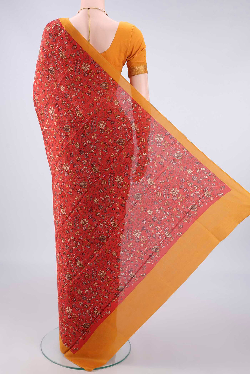 Flat view of Pure Silk Orange Printed Saree with Printed design on the body and Plain Border. 