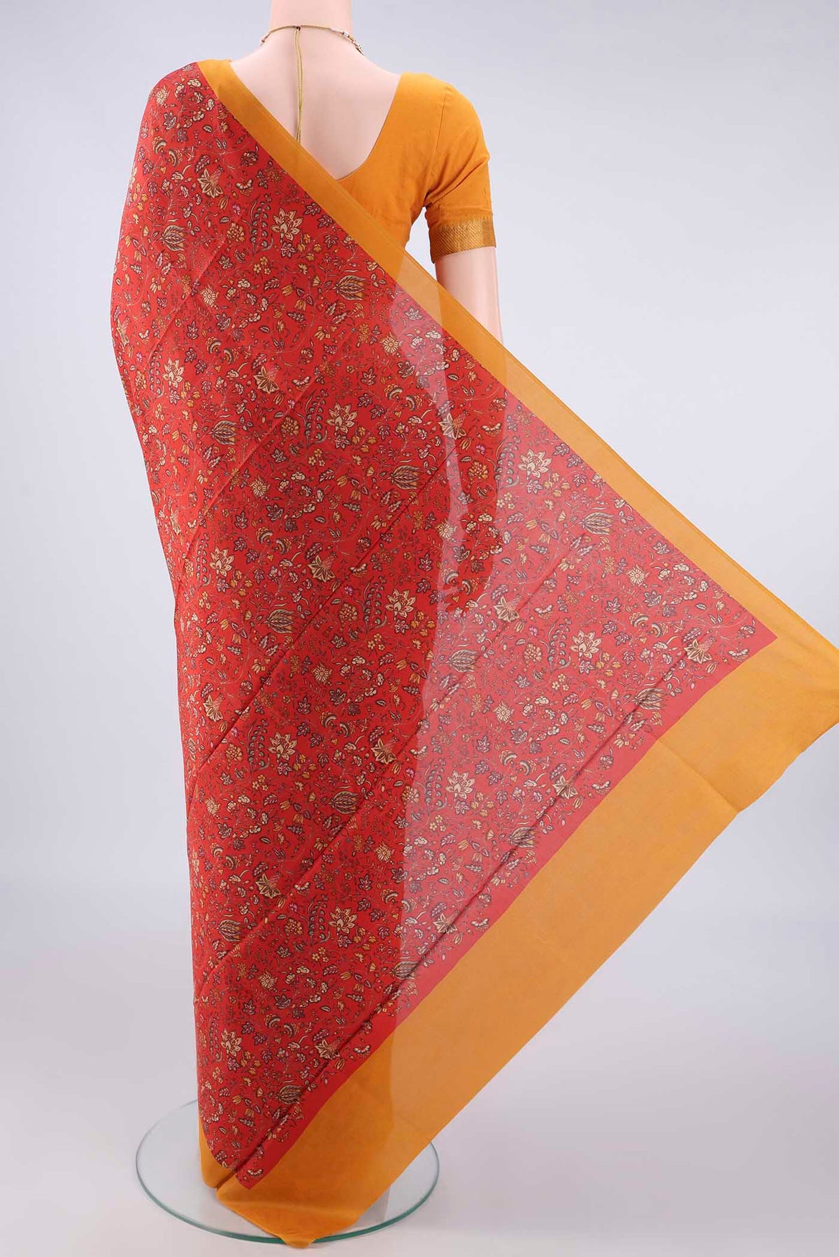 Flat view of Pure Silk Orange Printed Saree with Printed design on the body and Plain Border. 