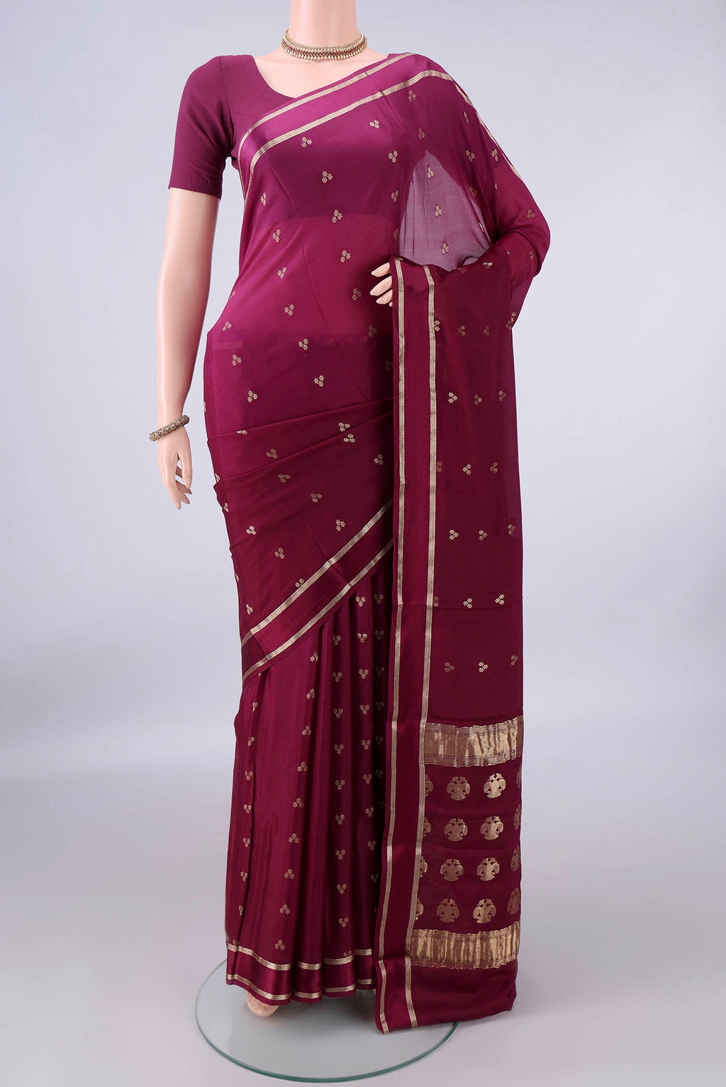 Magenta Mysore Crepe Saree with Zari Butta on the body and Zari Border.  displayed on a mannequin