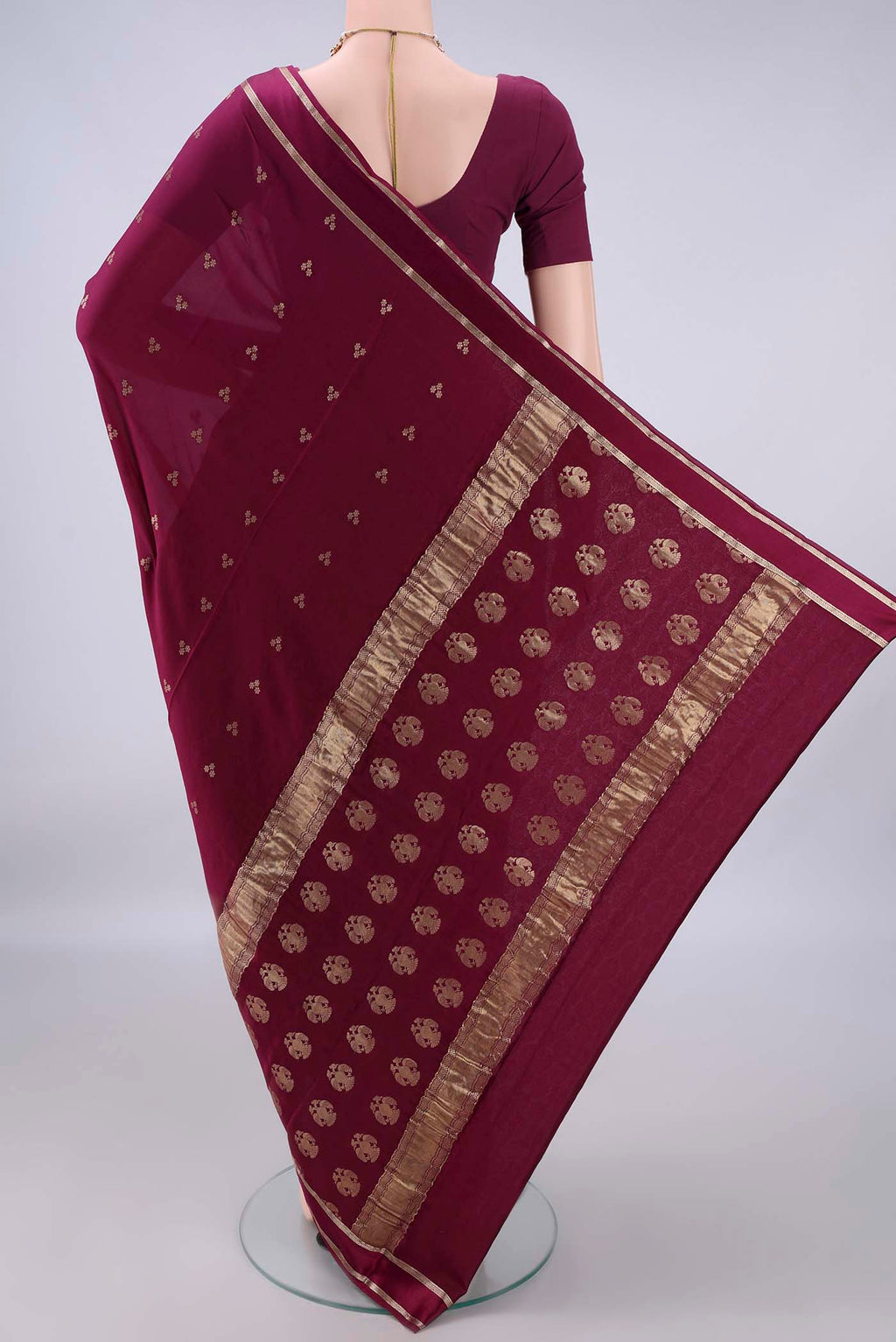 Flat view of Magenta Mysore Crepe Saree with Zari Butta on the body and Zari Border. 