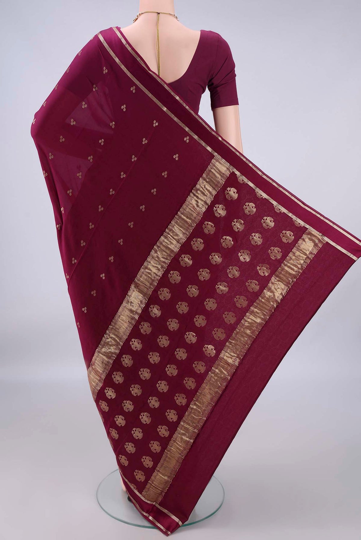 Flat view of Magenta Mysore Crepe Saree with Zari Butta on the body and Zari Border. 