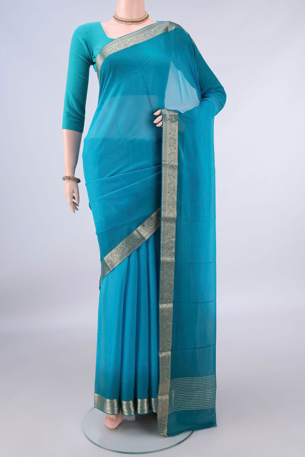 Blue Mysore Georgette Saree with Plain Body and Zari Border.  displayed on a mannequin