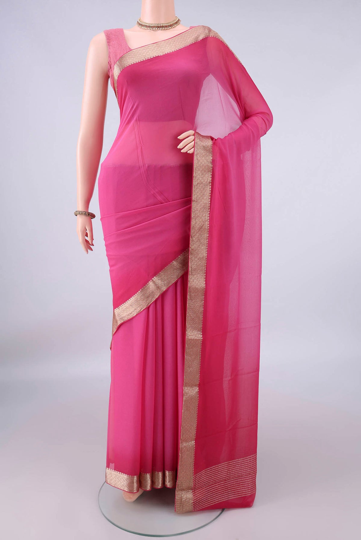 Pink Mysore Georgette Saree with Plain Body and Zari Border.  displayed on a mannequin