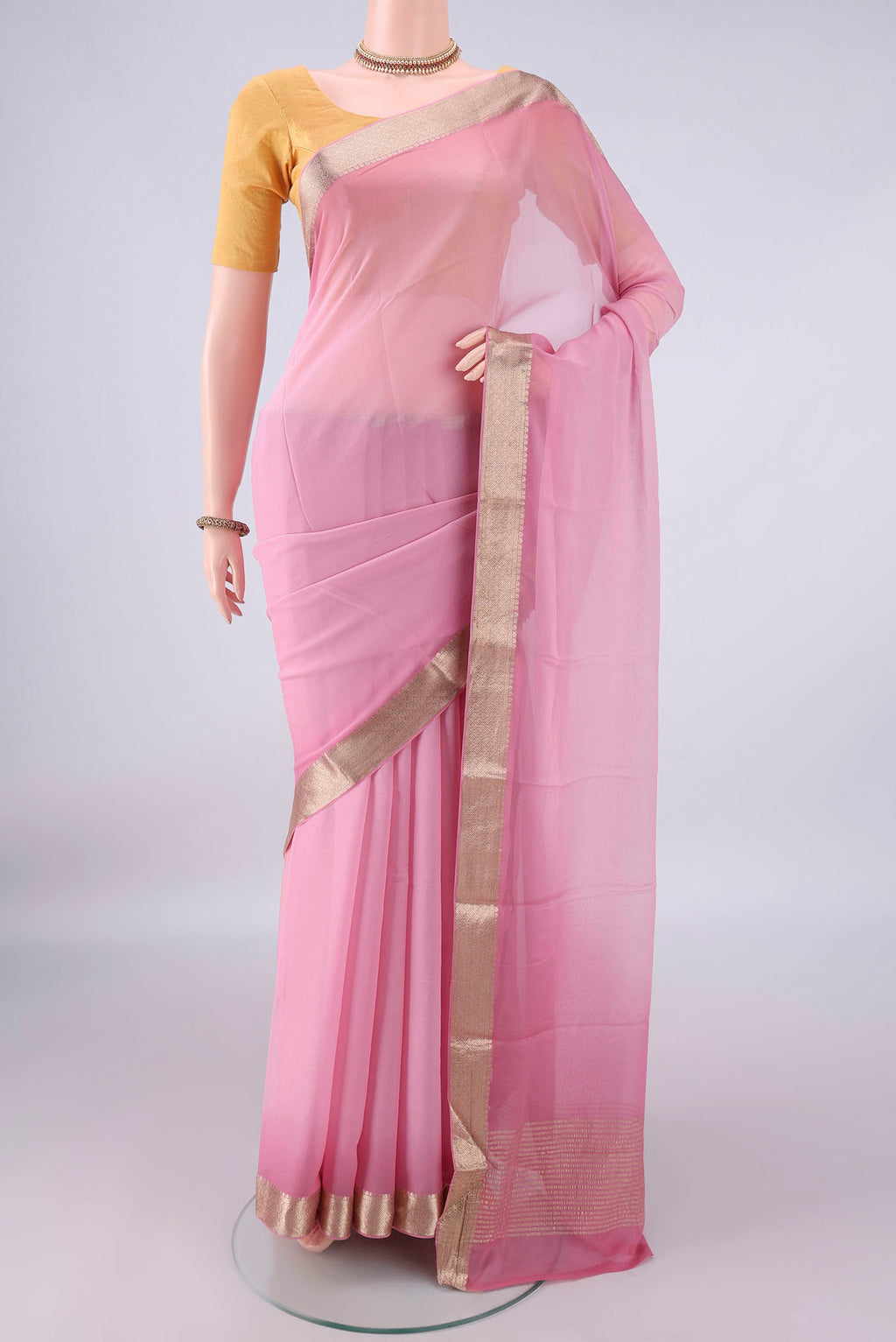 Rose pink Mysore Georgette Saree with Plain Body and Zari Border.  displayed on a mannequin