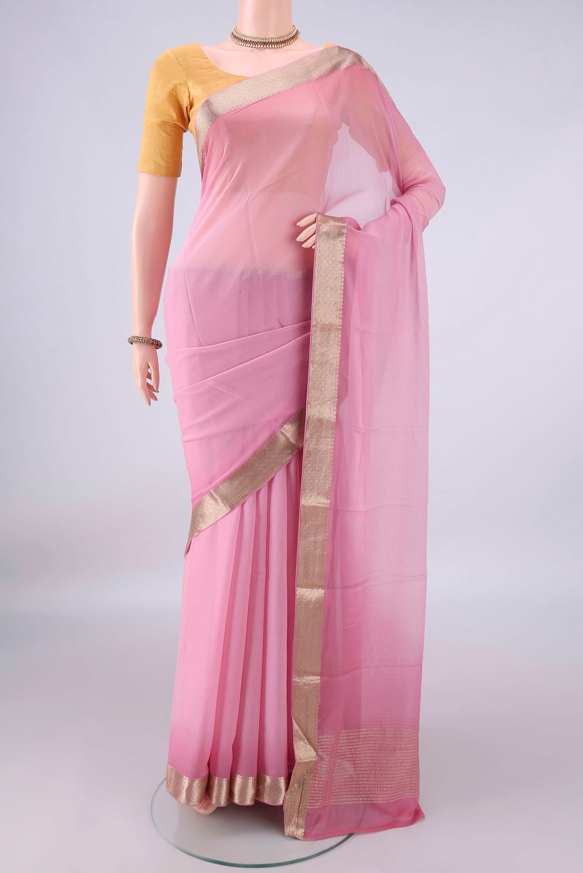 Rose pink Mysore Georgette Saree with Plain Body and Zari Border.  displayed on a mannequin