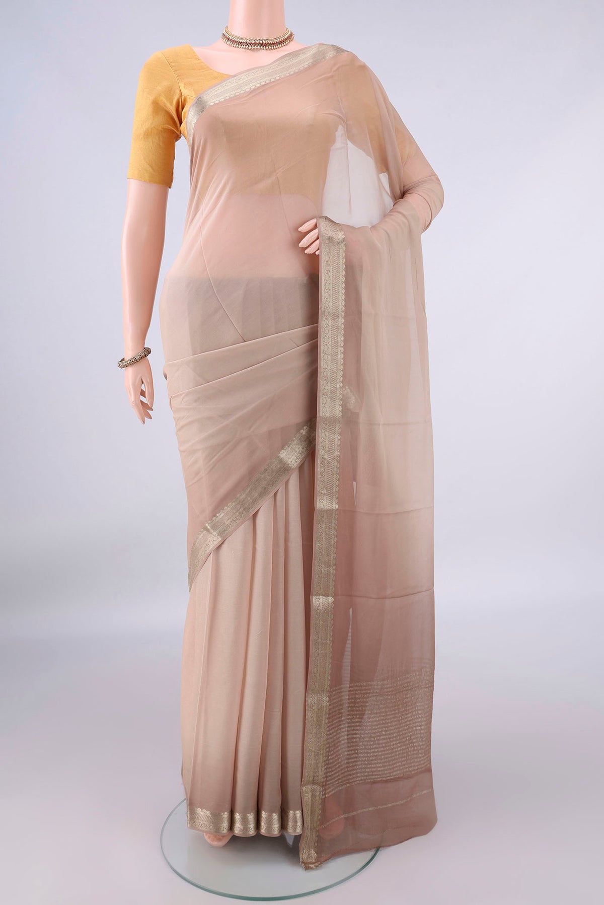 Beige Mysore Georgette Saree with Plain Body and Zari Border.  displayed on a mannequin