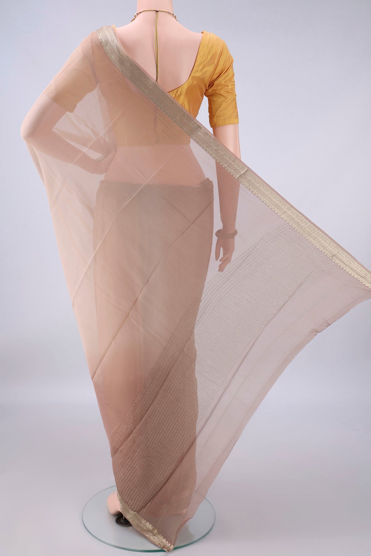 Flat view of Beige Mysore Georgette Saree with Plain Body and Zari Border. 