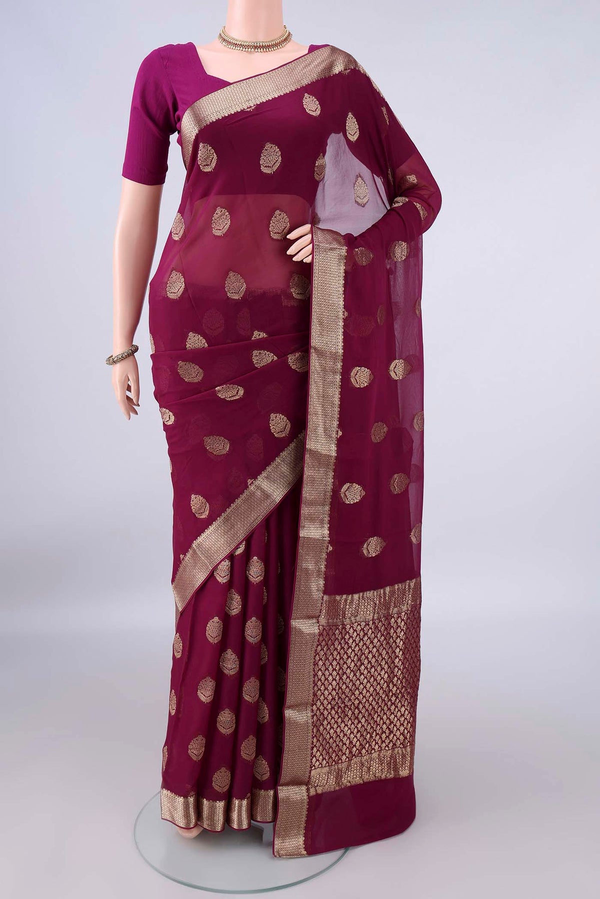 Magenta Mysore Georgette Saree with Zari Butta on the body and Zari Border.  displayed on a mannequin