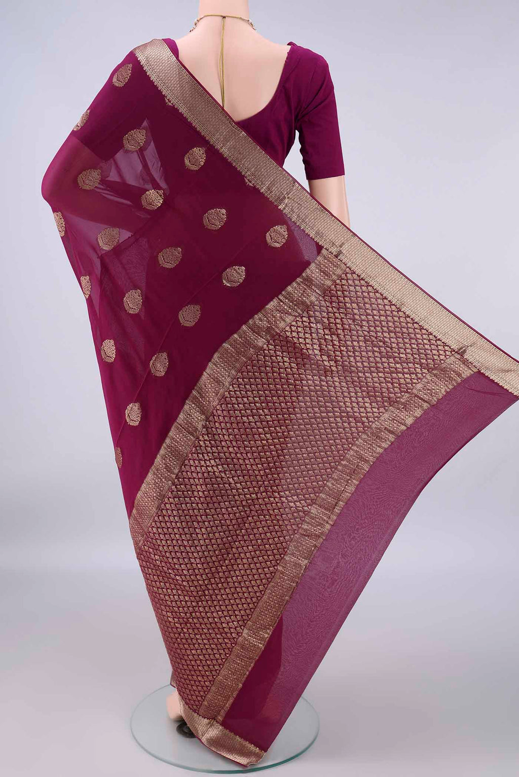 Flat view of Magenta Mysore Georgette Saree with Zari Butta on the body and Zari Border. 