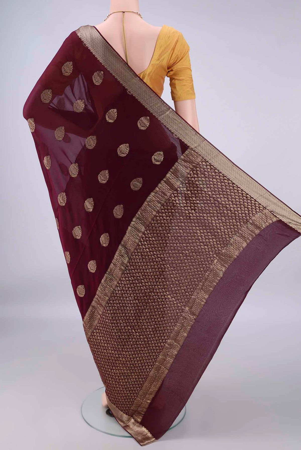 Flat view of Maroon Mysore Georgette Saree with Zari Butta on the body and Zari Border. 