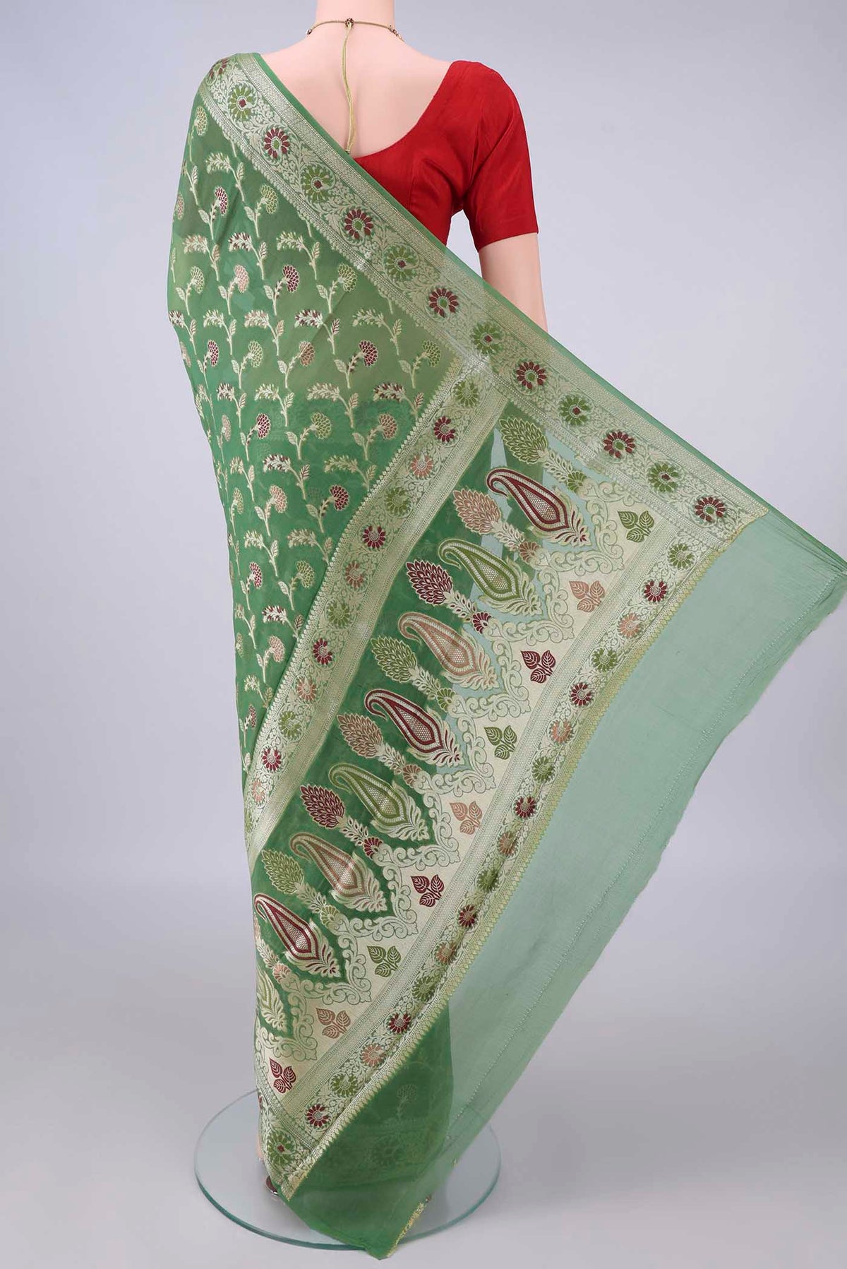 Flat view of Green Blended Banarasi Georgette Saree with Thread Brocade on the body and Zari And Thread Border. 
