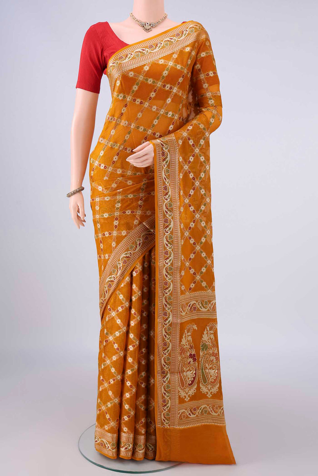 Mustard Blended Banarasi Georgette Saree with Thread Brocade on the body and Zari And Thread Border.  displayed on a mannequin