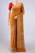 Mustard Blended Banarasi Georgette Saree with Thread Brocade on the body and Zari And Thread Border.  displayed on a mannequin