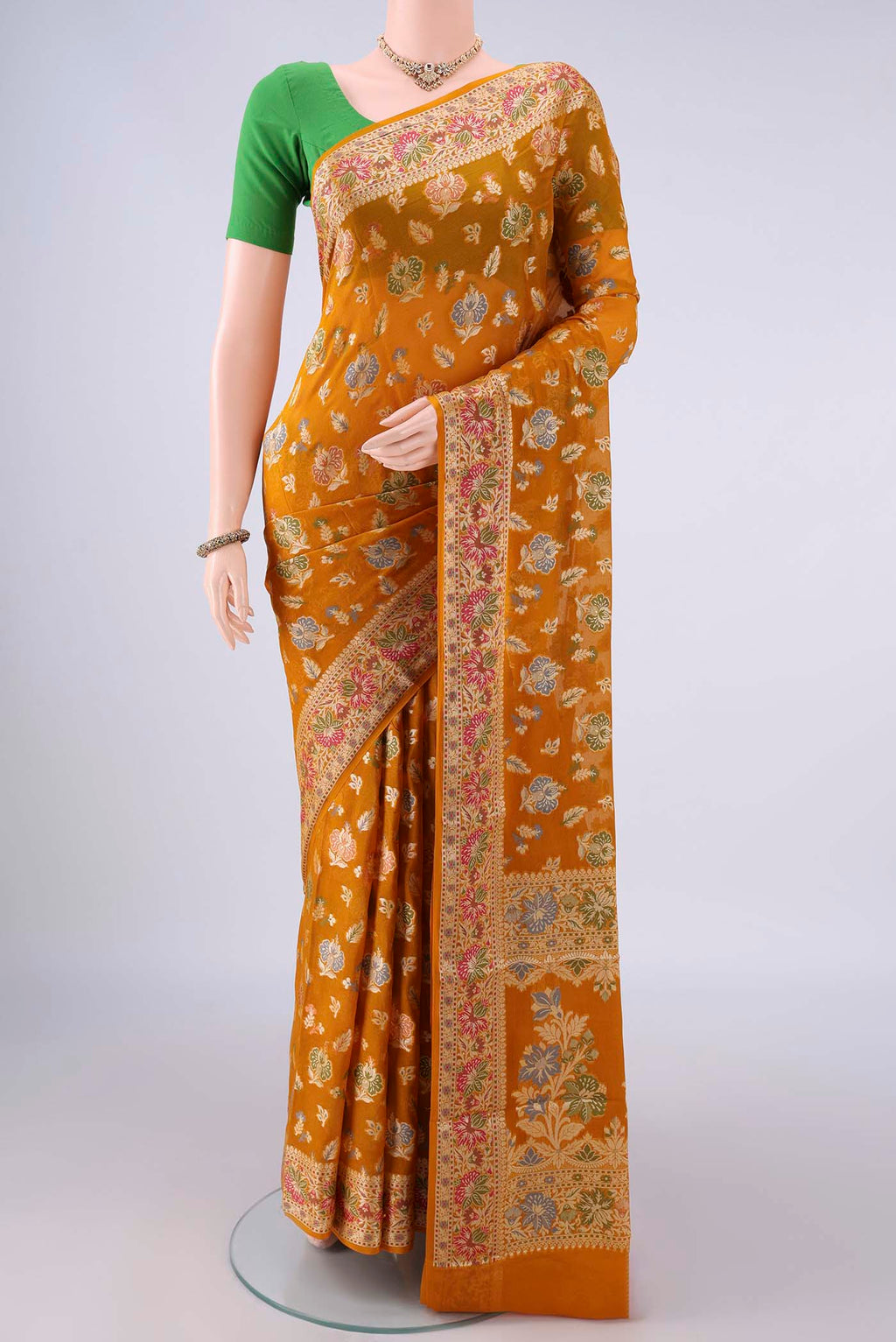Mustard Blended Banarasi Georgette Saree with Thread Butta on the body and Zari And Thread Border.  displayed on a mannequin