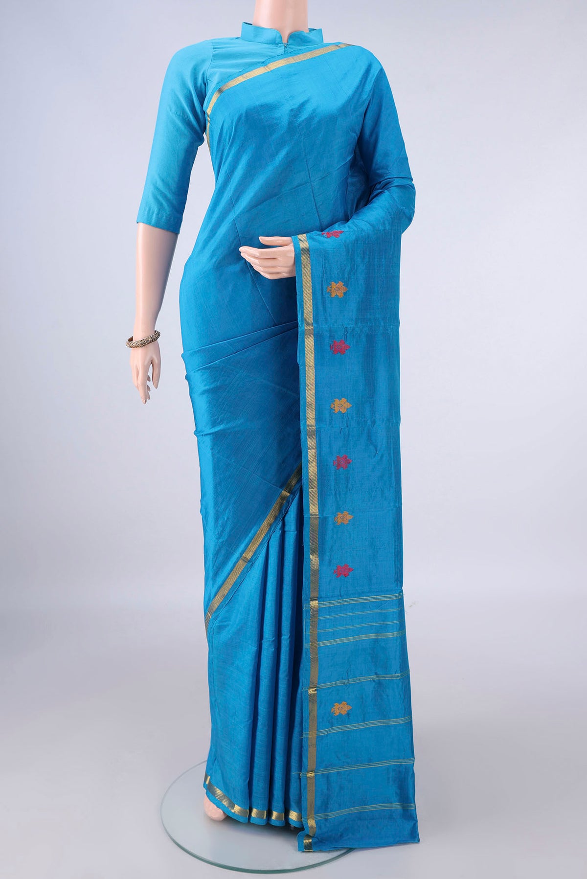 Pure Silk Blue Kanchipuram Saree with Plain Body and Zari Border.  displayed on a mannequin
