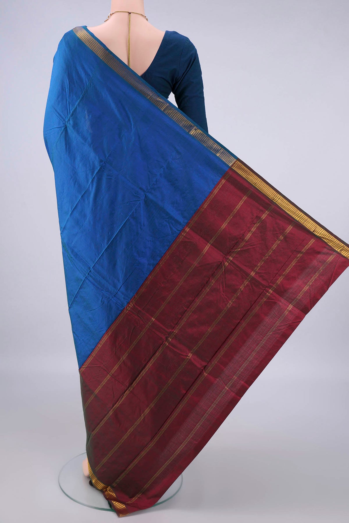 Flat view of Pure Silk Peacock Blue Kanchipuram Saree with Plain Body and Zari Border. 