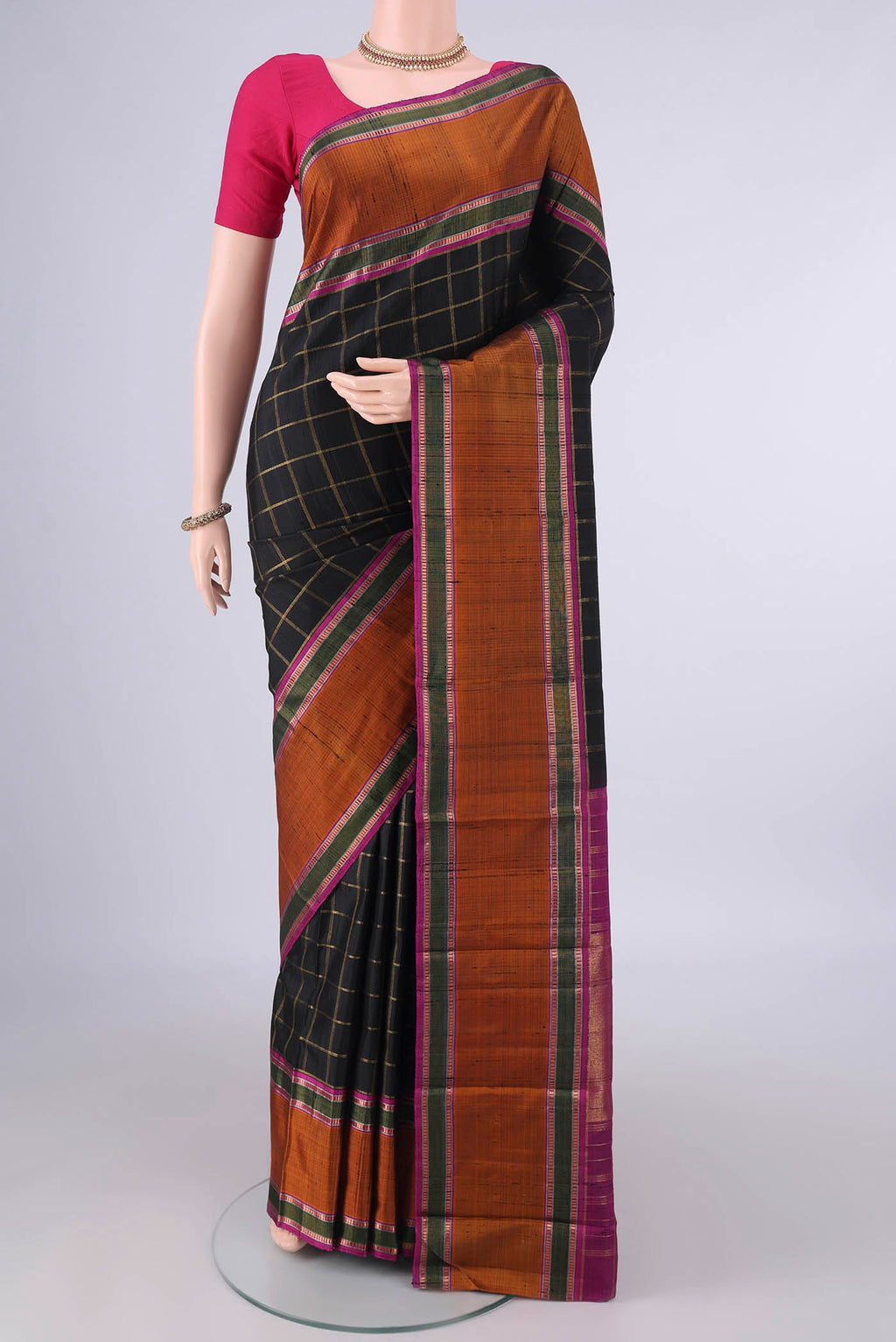 Pure Silk Black Kanchipuram Saree with Checked design on the body and Plain Border.  displayed on a mannequin
