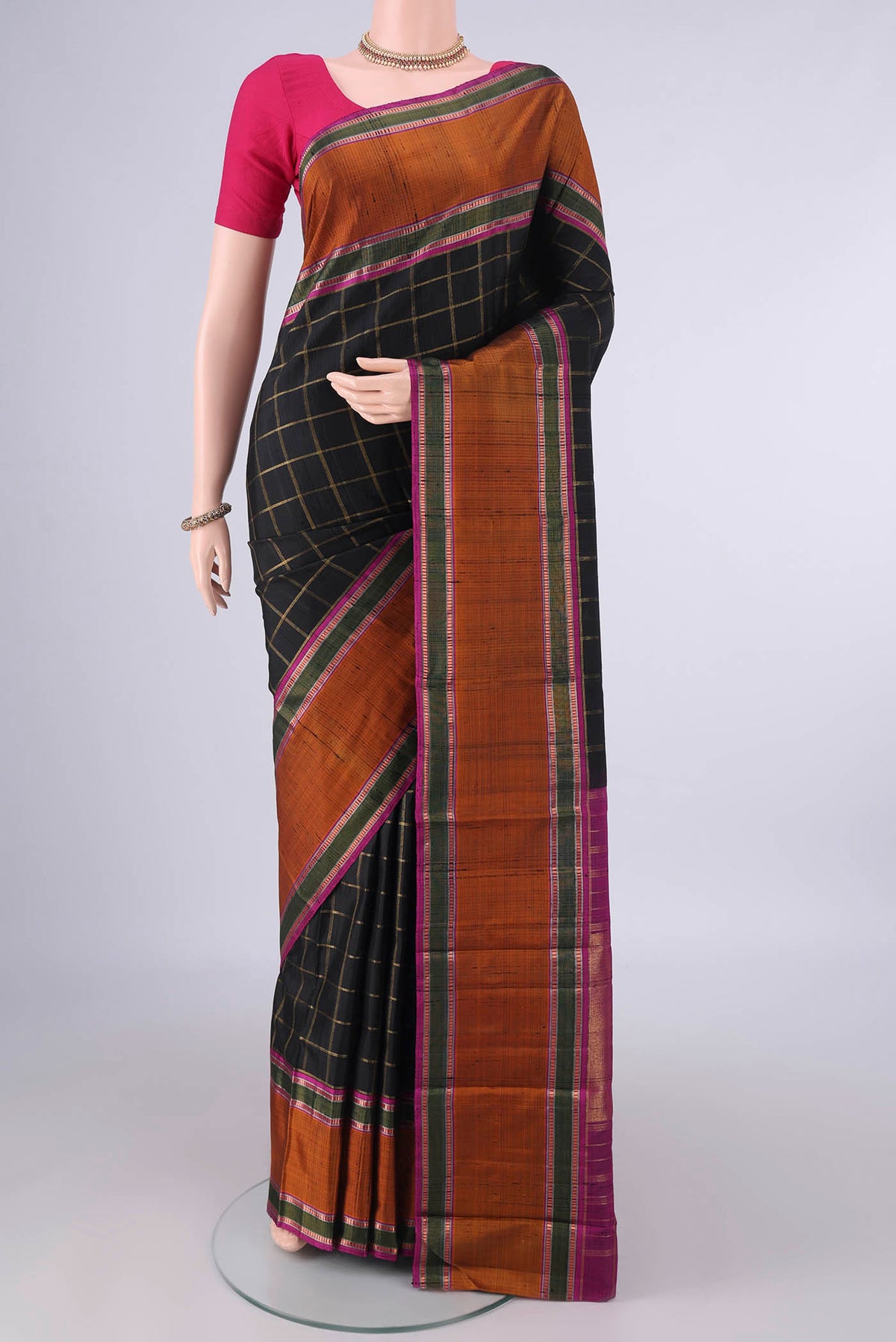 Pure Silk Black Kanchipuram Saree with Checked design on the body and Plain Border.  displayed on a mannequin