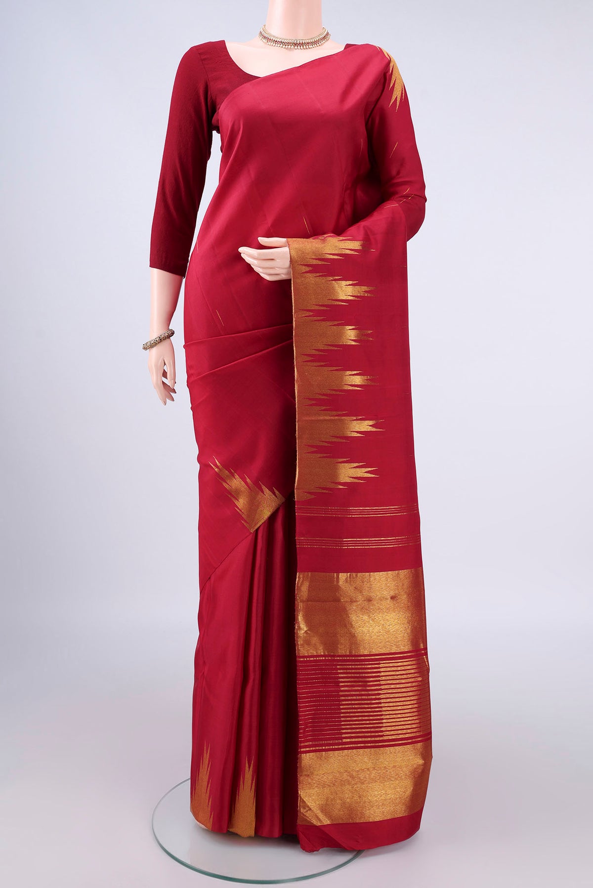 Pure Silk Red Kanjivaram Saree with Plain Body and Temple Border.  displayed on a mannequin