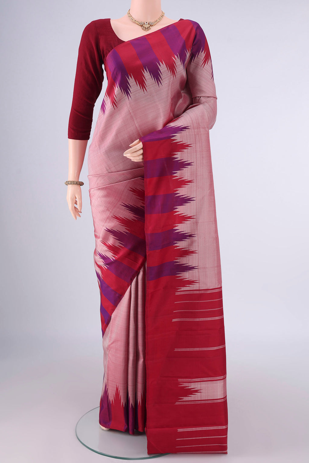 Pure Silk Peach Kanjivaram Saree with Plain Body and Temple Border.  displayed on a mannequin