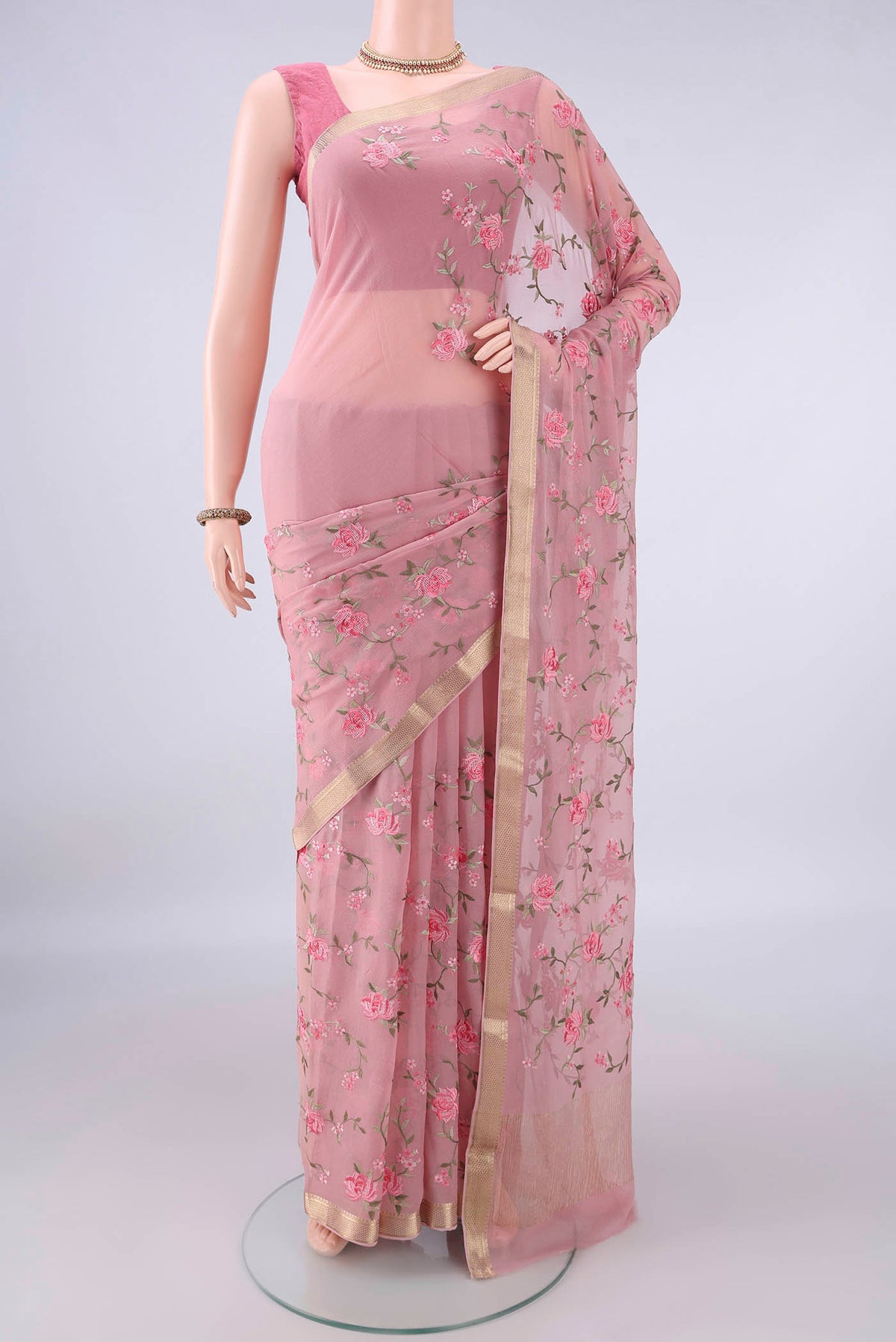 Peach Mysore Chiffon Saree with Embroidery on the body and Zari Border.  displayed on a mannequin