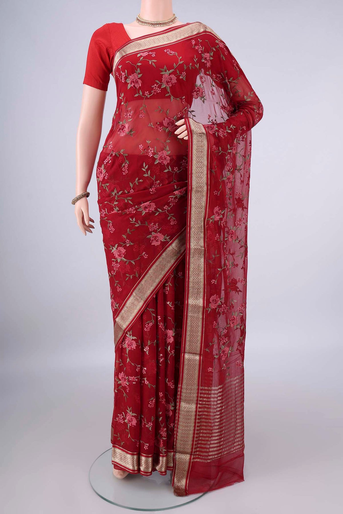 Red Mysore Chiffon Saree with Embroidery on the body and Zari Border.  displayed on a mannequin