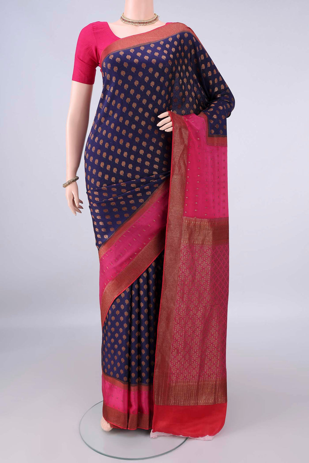 Navy Blue Mysore Crepe Saree with Zari Butta on the body and Zari Border.  displayed on a mannequin