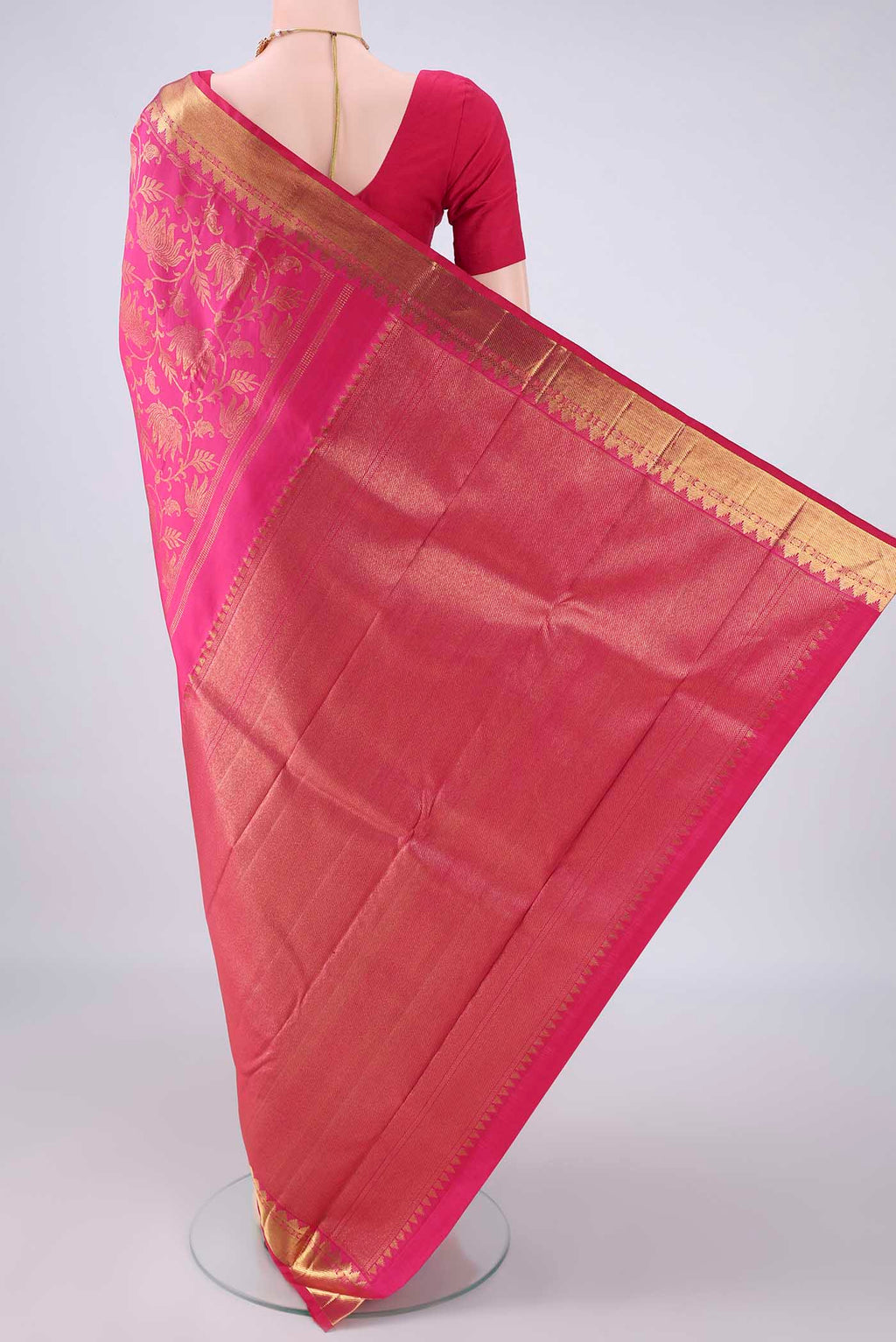 Flat view of Pure Silk Rani Pink Kanchipuram Saree with Zari Brocade on the body and Zari Border. 