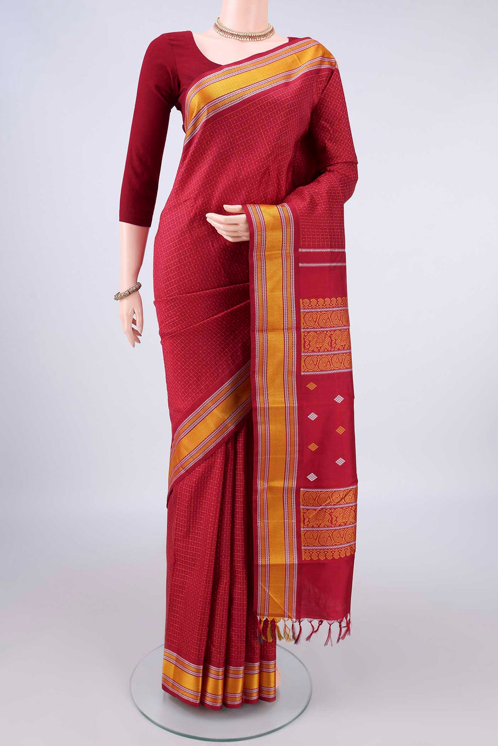 Pure Silk Red Kanjivaram Saree with Checked design on the body and Thread Border.  displayed on a mannequin